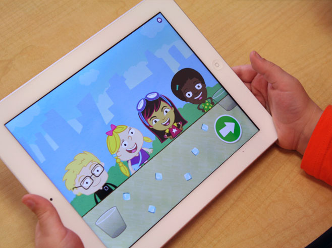 A child holds an iPad showing four characters at a table with cups and ice cubes on it.