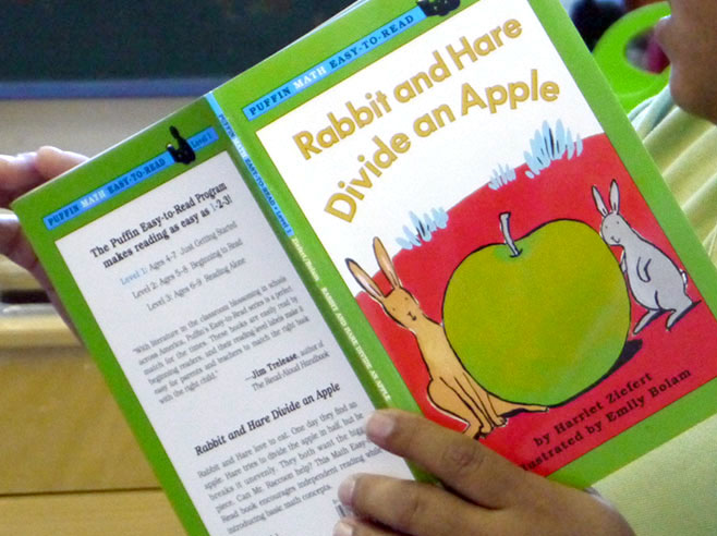 Close-up of the cover of the book Rabbit and Hare Divide an Apple.