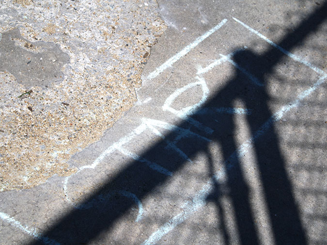 The word Start is written in chalk on the playground pavement.