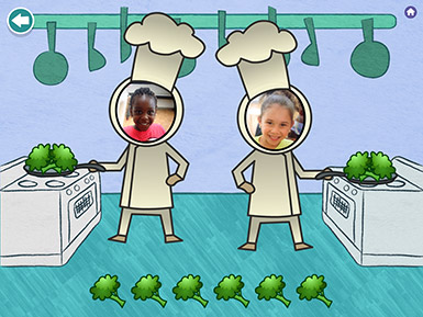 A screenshot from the Early Math with Gracie & Friends Photo Friends app shows the photos of two preschool girls as the faces of chef characters in the app who are seen cooking broccoli at stoves.