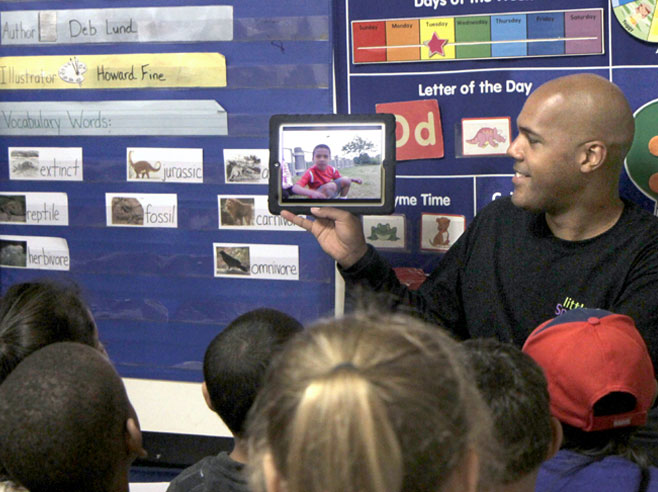 A teacher showing his class a video on the iPad