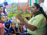 A teacher reads the book Bean Thirteen aloud to a group of preschool children.