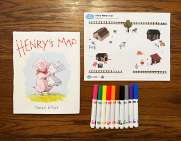 David Elliot’s book “Henry’s Map” next to a printout of a farm scene and a pile of markers.