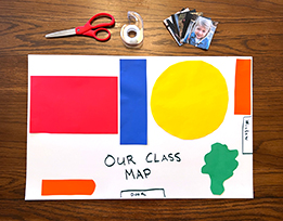 A handmade map of a classroom with objects depicted by brightly colored shapes, next to scissors, tape, and images of children.