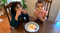 Two children eating fruit.