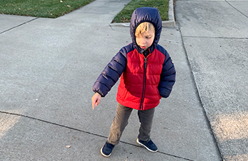 Child pointing to a driveway ramp.