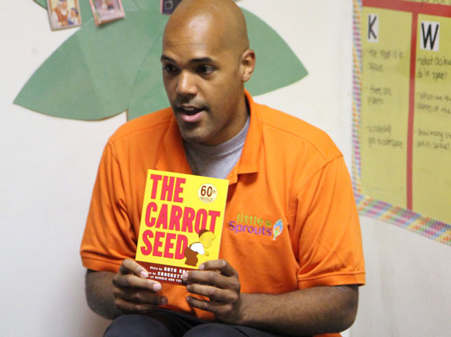 Teacher holding up The Carrot Seed book.