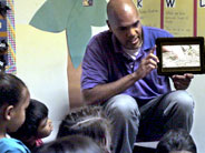 Teacher shows a video to students.