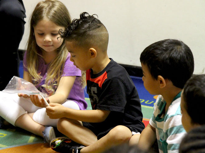 Students examining seeds in a bag.