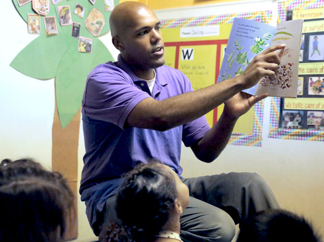 Teacher reads book to students.