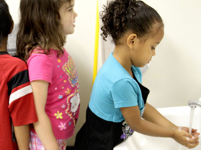 Students wash their hands.