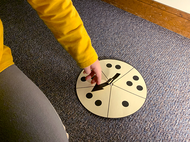 Student spins a dot spinner.