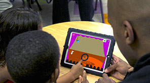 Two students and teacher playing Shadow Play app on iPad.
